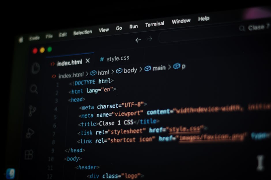 A computer screen displaying HTML code with tags such as <html>, <head>, <title>, and <link>, associated with web development. The code is color-coded with syntax highlighting, featuring blue, red, an
